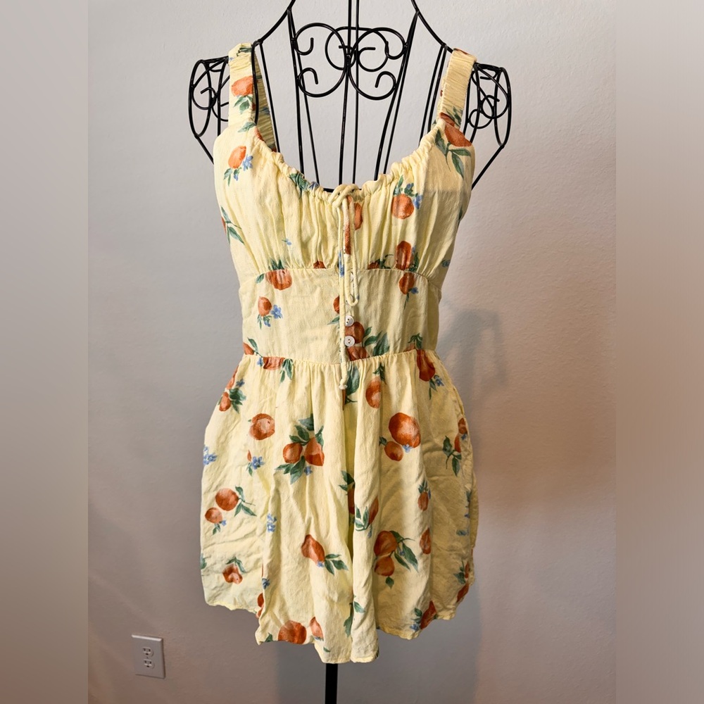 Yellow romper with tangerines and pockets